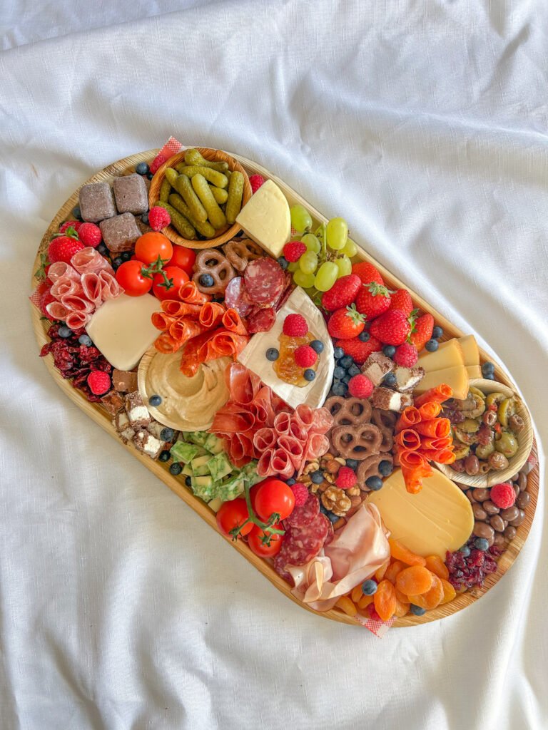 Grazing platter with artisan cheese, cured meats, fruit and crackers